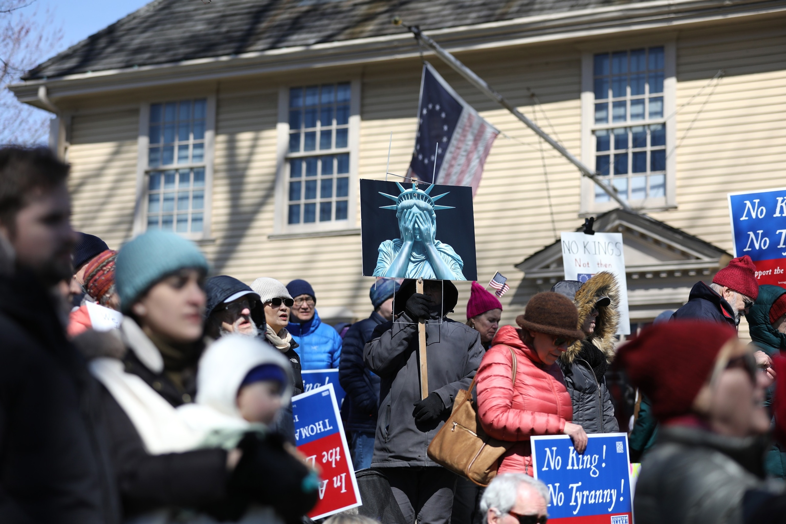 PHOTO: "No Kings" demonstrators hold a rally in Lexington, Mass., on March 28, 2026, across the street from the Lexington Battle Green, where the first battle of the American Revolution took place.