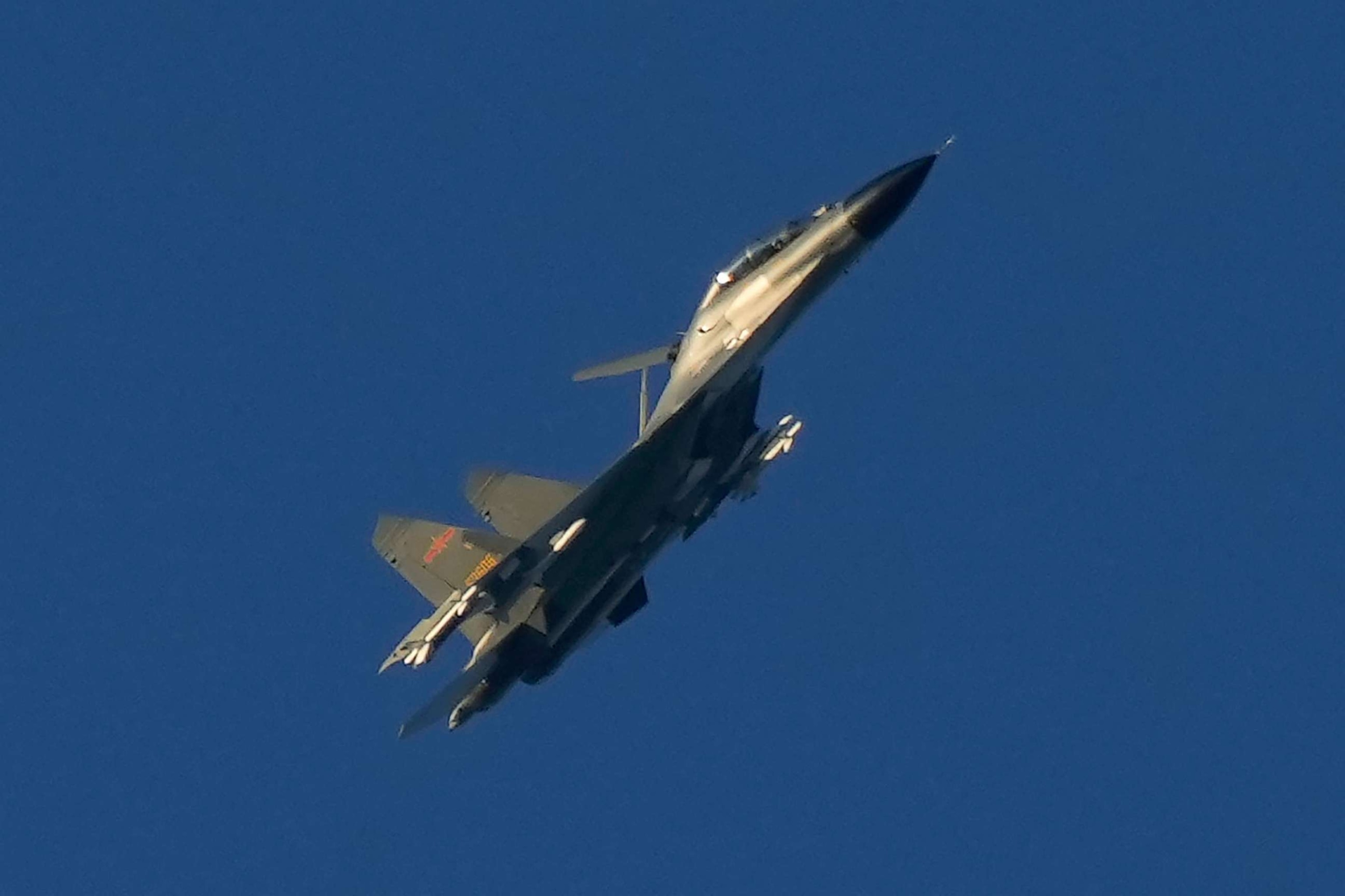 PHOTO: A Chinese J-11 military fighter jet flies above the Taiwan Strait near Pingtan, the closest land of mainland China to the island of Taiwan, in Pingtan in southeastern China's Fujian Province, Aug. 5, 2022. 