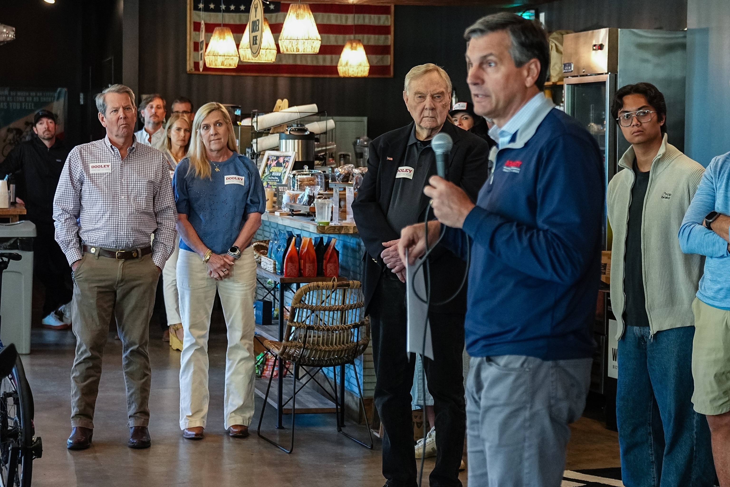 Georgia Gov. Brian Kemp and wife Marty Kemp, second left, watch as Derek Dooley, Republican U.S. Senate candidate for Georgia, second right, speaks during a campaign event at Whitetail Coffee Shop in Milton, Georgia, on Friday, May 15, 2026.