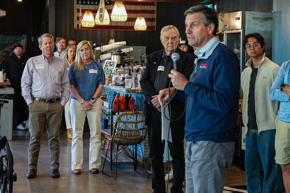 Georgia Gov. Brian Kemp and wife Marty Kemp, second left, watch as Derek Dooley, Republican U.S. Senate candidate for Georgia, second right, speaks during a campaign event at Whitetail Coffee Shop in Milton, Georgia, on Friday, May 15, 2026.