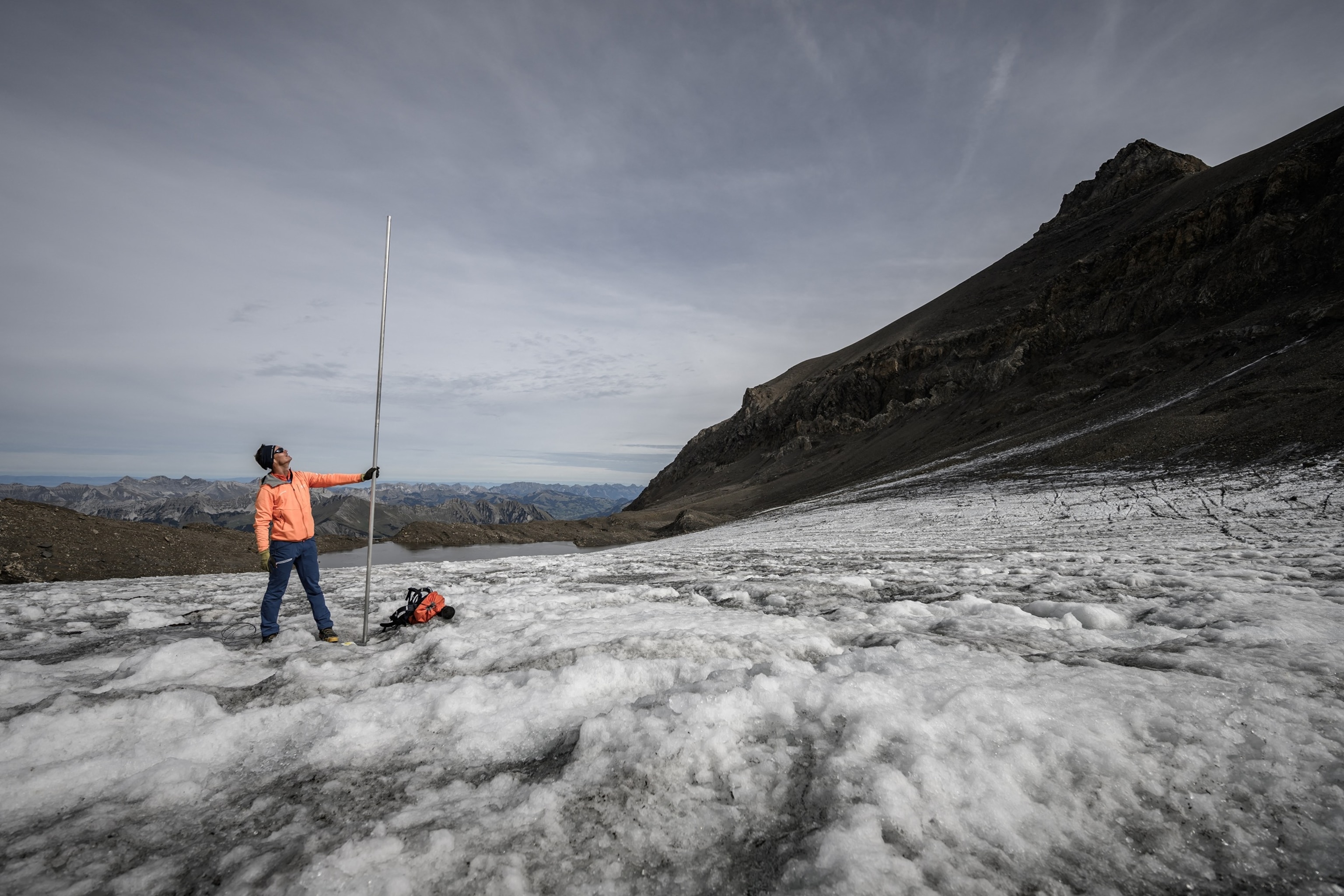 PHOTO: This photograph shows glaciologist and head of 'Glacier Monitoring in Switzerland' (GLAMOS) network Matthias Huss posing with a four-metre-long measuring stake indicating the amount of ice that melted over the past year, Sept. 24, 2026.