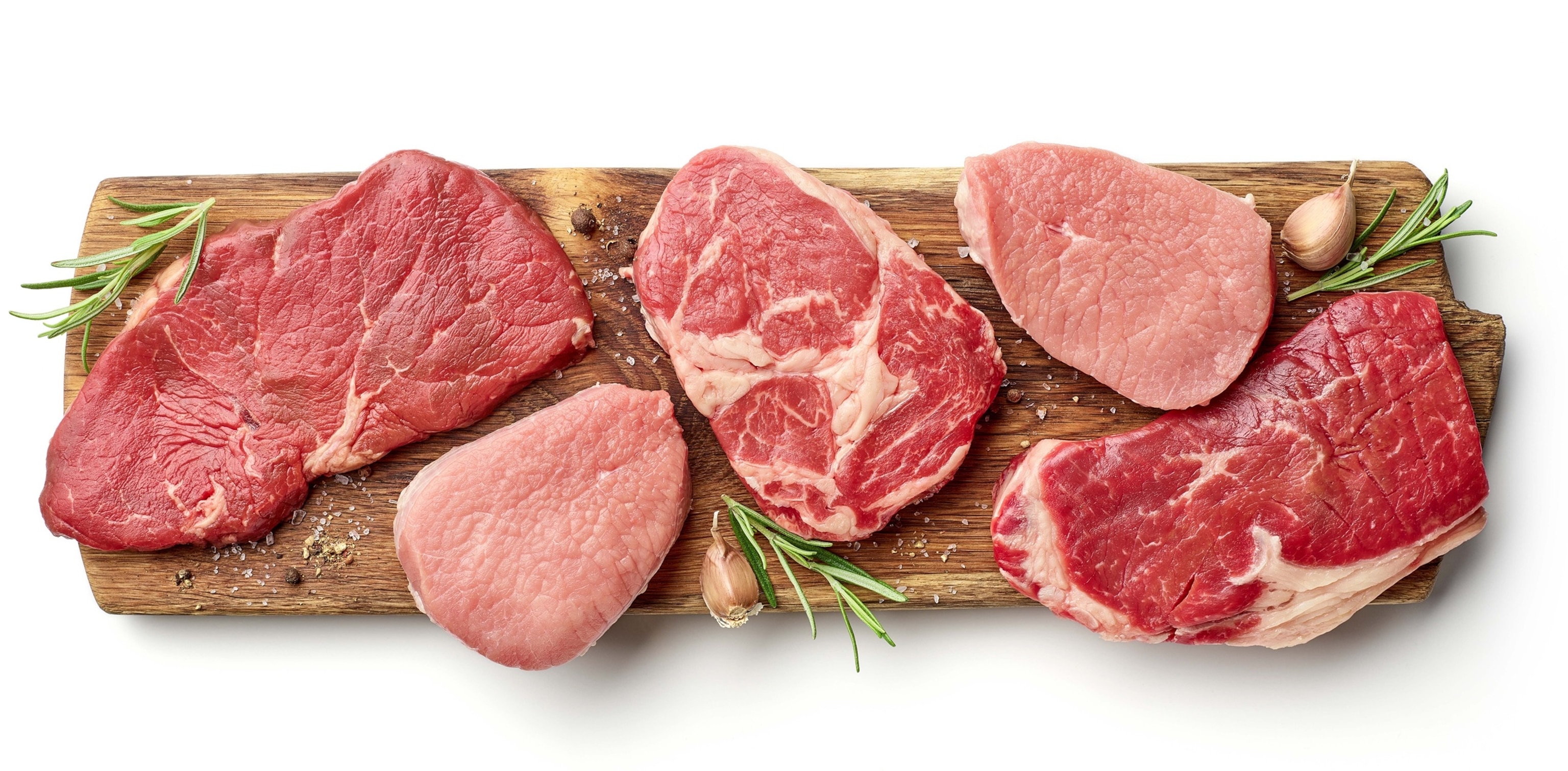PHOTO: Various types of steak on wooden board isolated on white, from above