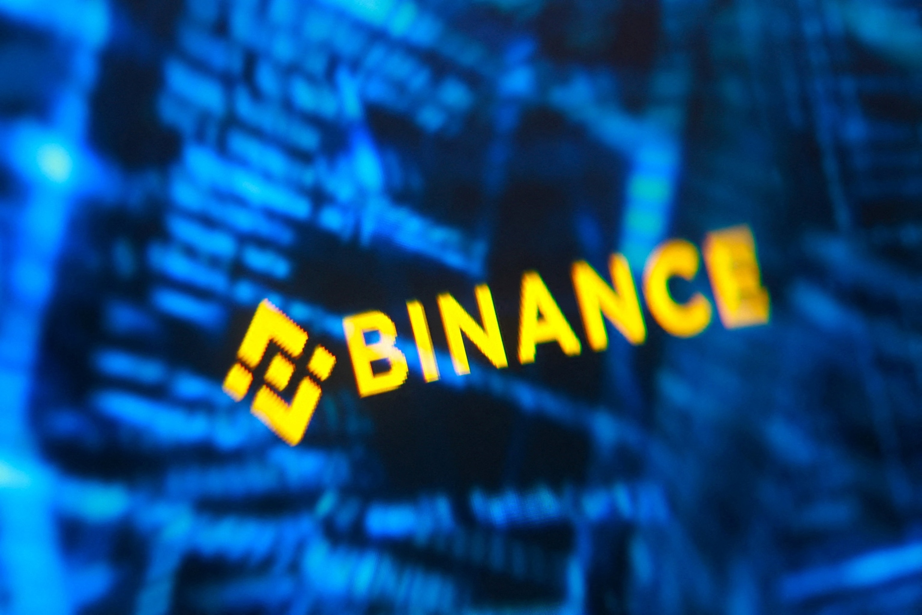 PHOTO: Illustration shows Binance logo and hacker code