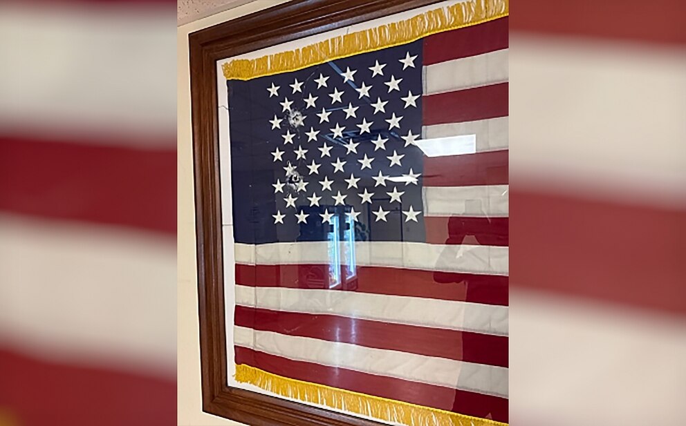 PHOTO: In a photo provided by DHS, bullet holes are seen in an American flag display following a shooting at an Immigration and Customs Enforcement field office in Dallas, Texas, September 24, 2025. 