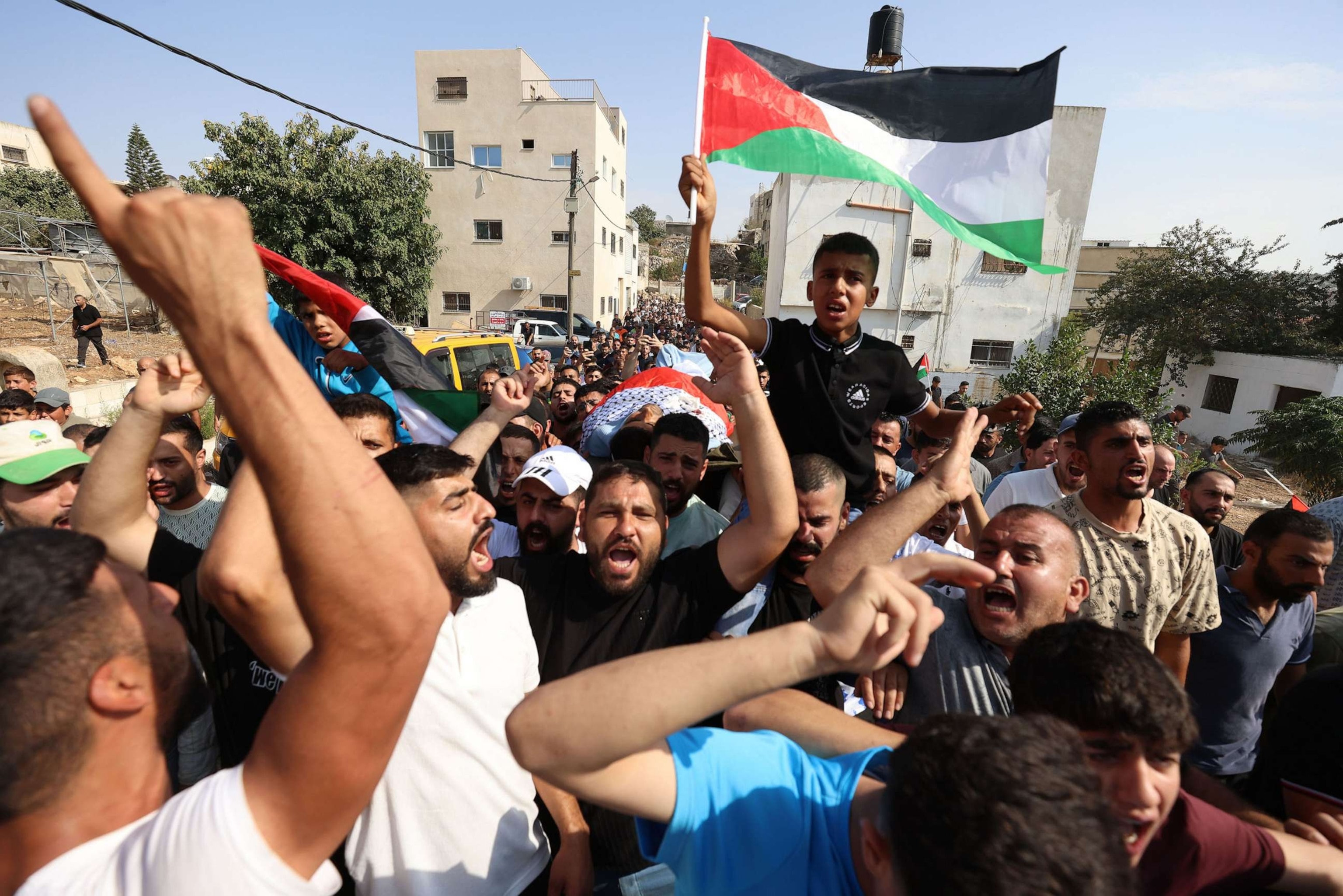 PHOTO: One of the sons of late Palestinian farmer Bilal Muhammad Saleh waves a Palestinian flag during his father's funeral procession at Al Sawiya village near the West Bank city of Nablus, Oct. 28, 2023.