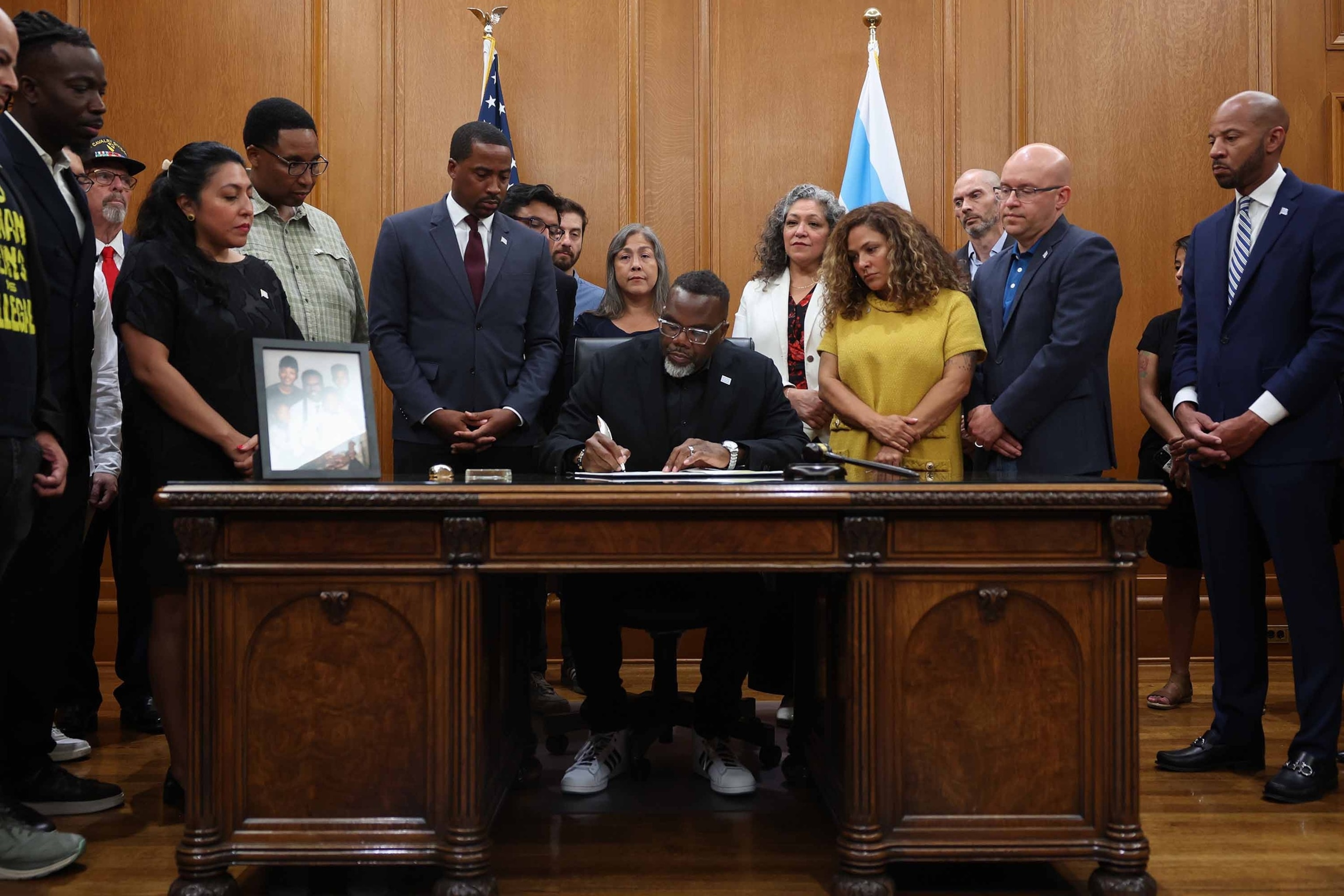 Mayor Brandon Johnson signs an executive order titled "Protecting Chicago," in response to the possible local deployment of federal military and other personnel in the coming days, at City Hall, on Saturday, Aug. 30, 2025, in Chicago.