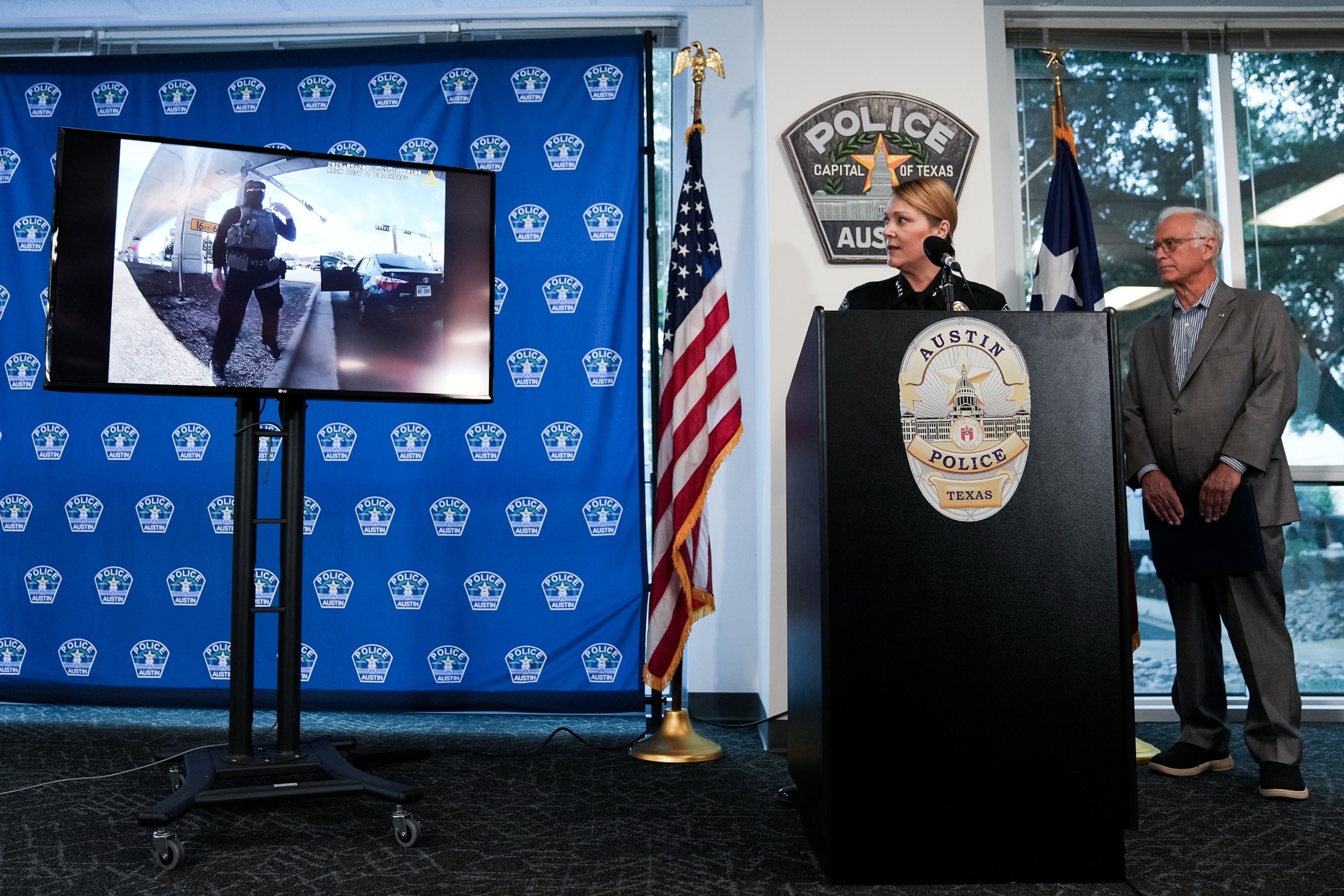 PHOTO: Austin Police Chief Lisa Davis, left, and Mayor Kirk Watson watch as footage from a body-worn camera is played during a news conferenc, September 22, 2026, providing an update after an ICE agent shot and wounded Wilber Garces Perez.