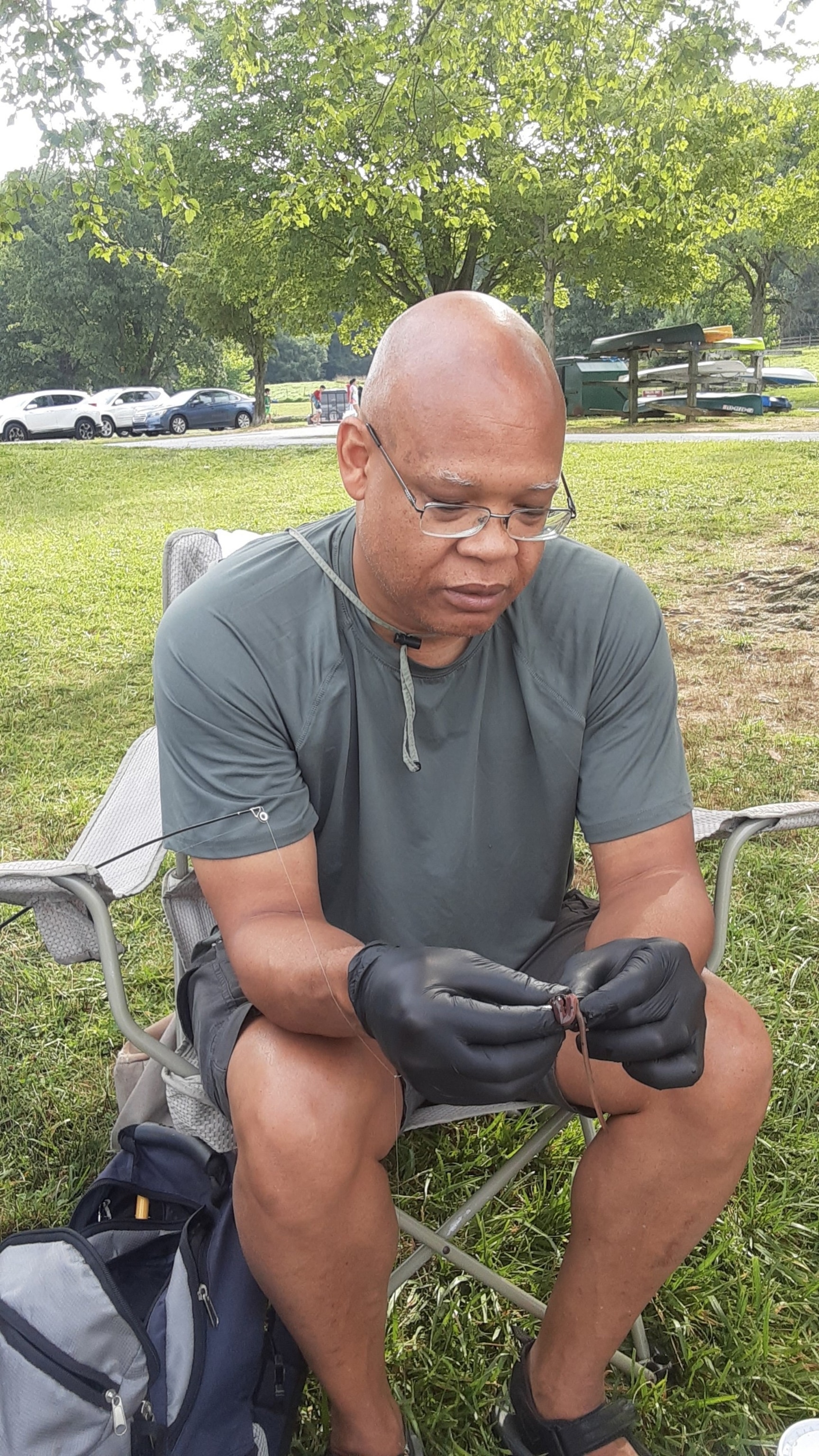 PHOTO: Frantz Dickerson hooks a fishing worm for one of his grandchildren. 