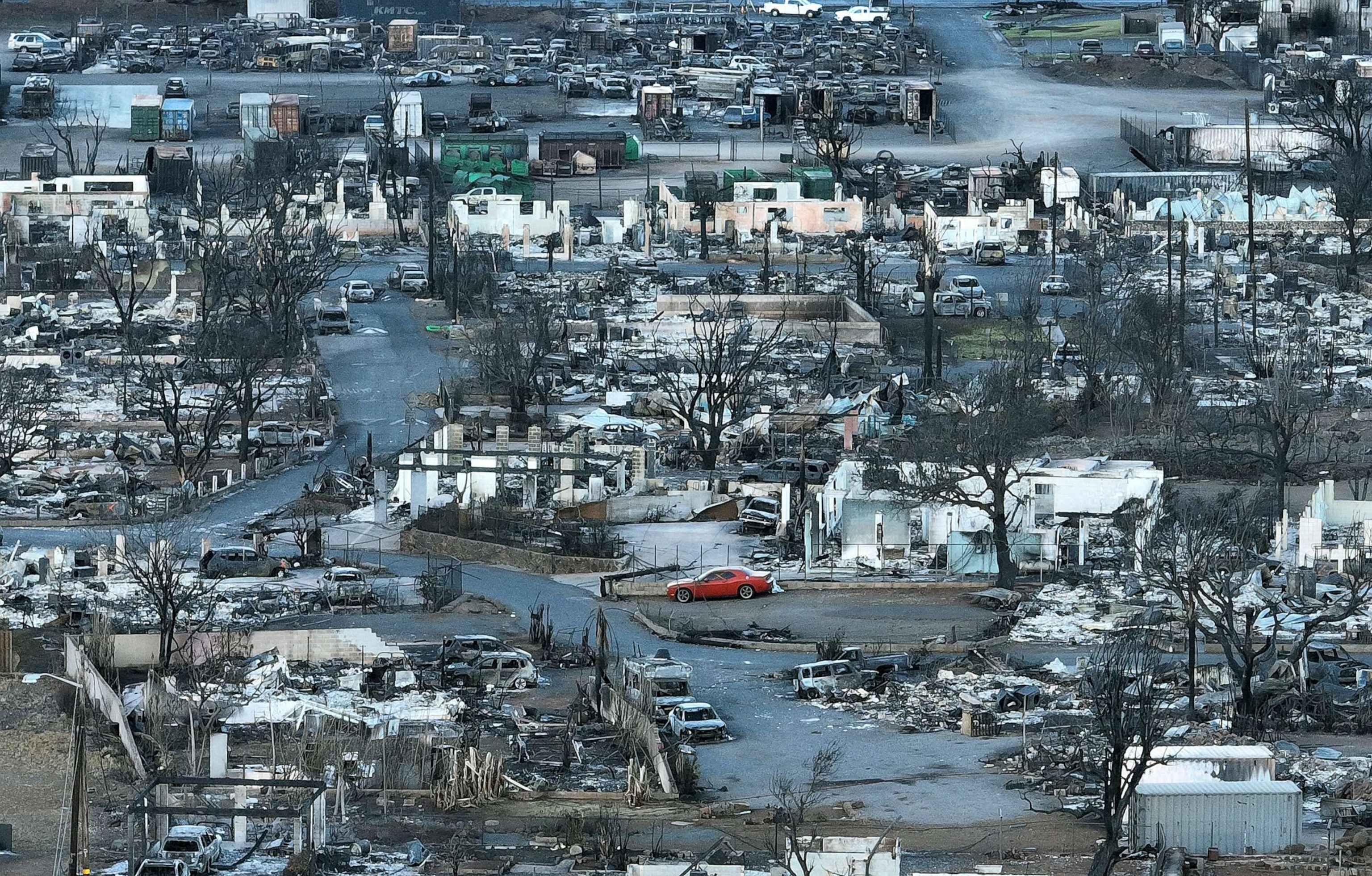 PHOTO: Burned cars and homes are seen in a neighborhood that was destroyed by a wildfire, Aug.18, 2023, in Lahaina, Hawaii.