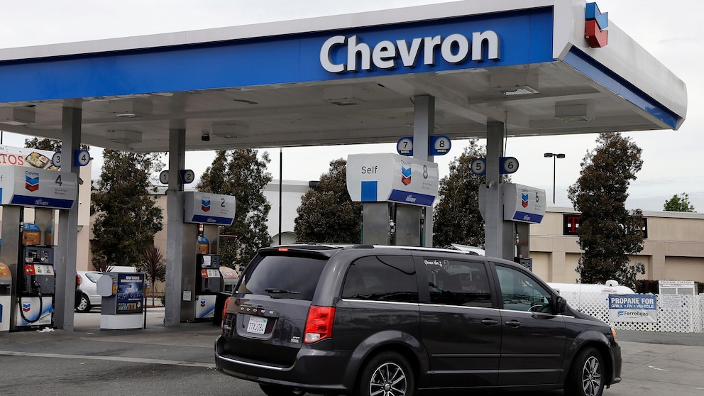 FILE - A motorist drives near the pumps at a Chevron gas station in Oakland, Calif., on April 25, 2017. Chevron is buying Hess Corp. for $53 billion as the biggest U.S. oil companies use a recent windfall in profits to buy up smaller competitors, Chevron said in a press release Monday, Oct. 23, 2023. (AP Photo/Ben Margot, File)
