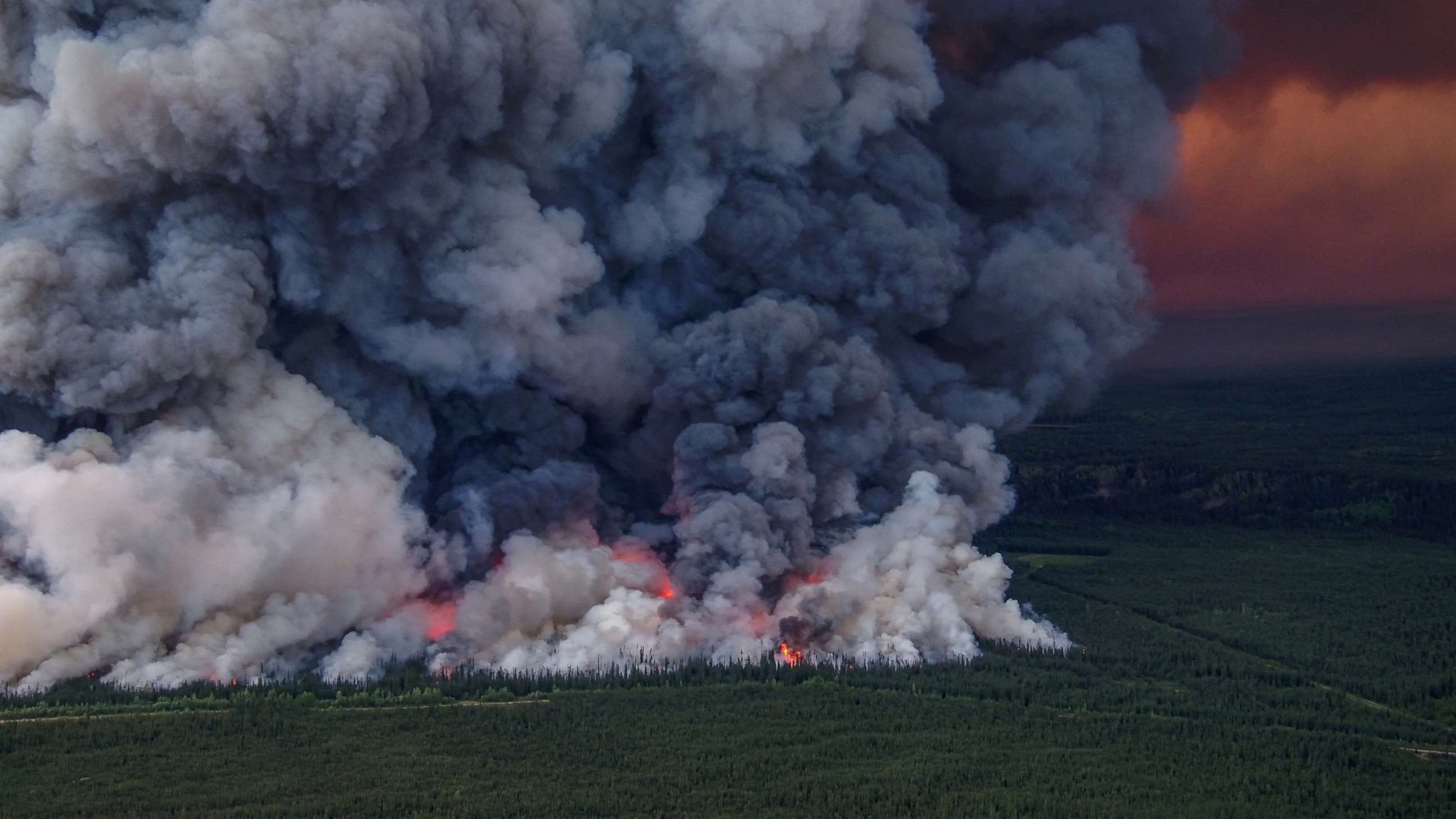 PHOTO: Smoke billows upwards from a planned ignition by firefighters tackling the Donnie Creek Complex wildfire south of Fort Nelson, British Columbia, Canada, June 3, 2023.