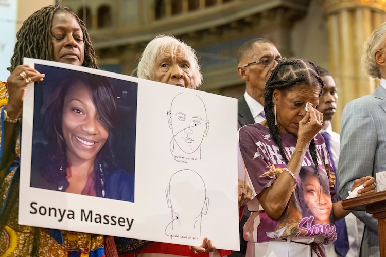 PHOTO: Donna Massey, center right, wipes tears from her face during a press conference, July 30, 2024, over the shooting death of her daughter Sonya, who was killed by former Illinois sheriff's deputy Sean Grayson.