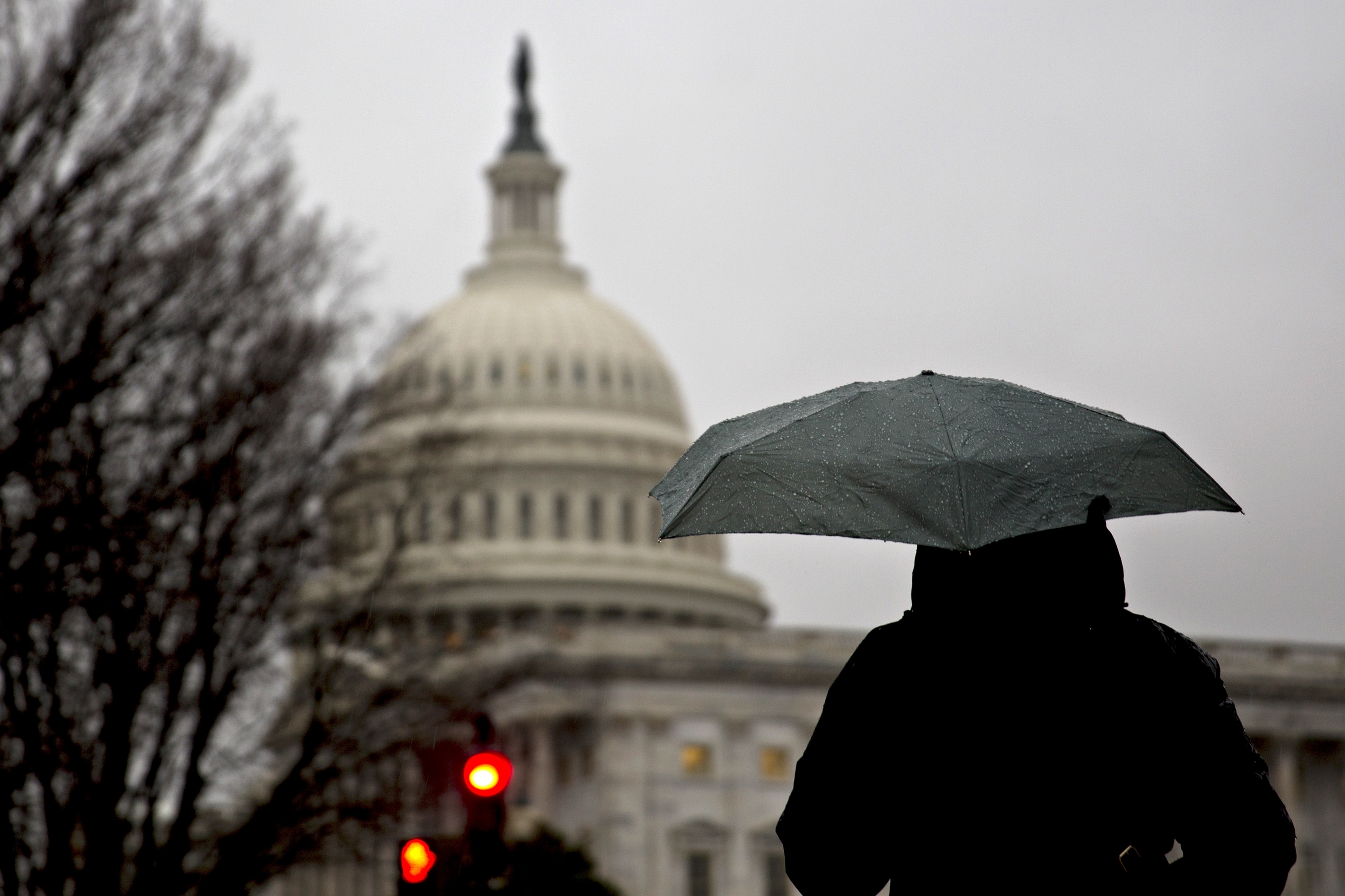 PHOTO: A pedestrian holds an umbrella near the U.S. Capitol building in Washington, D.C., Jan. 3, 2017. 