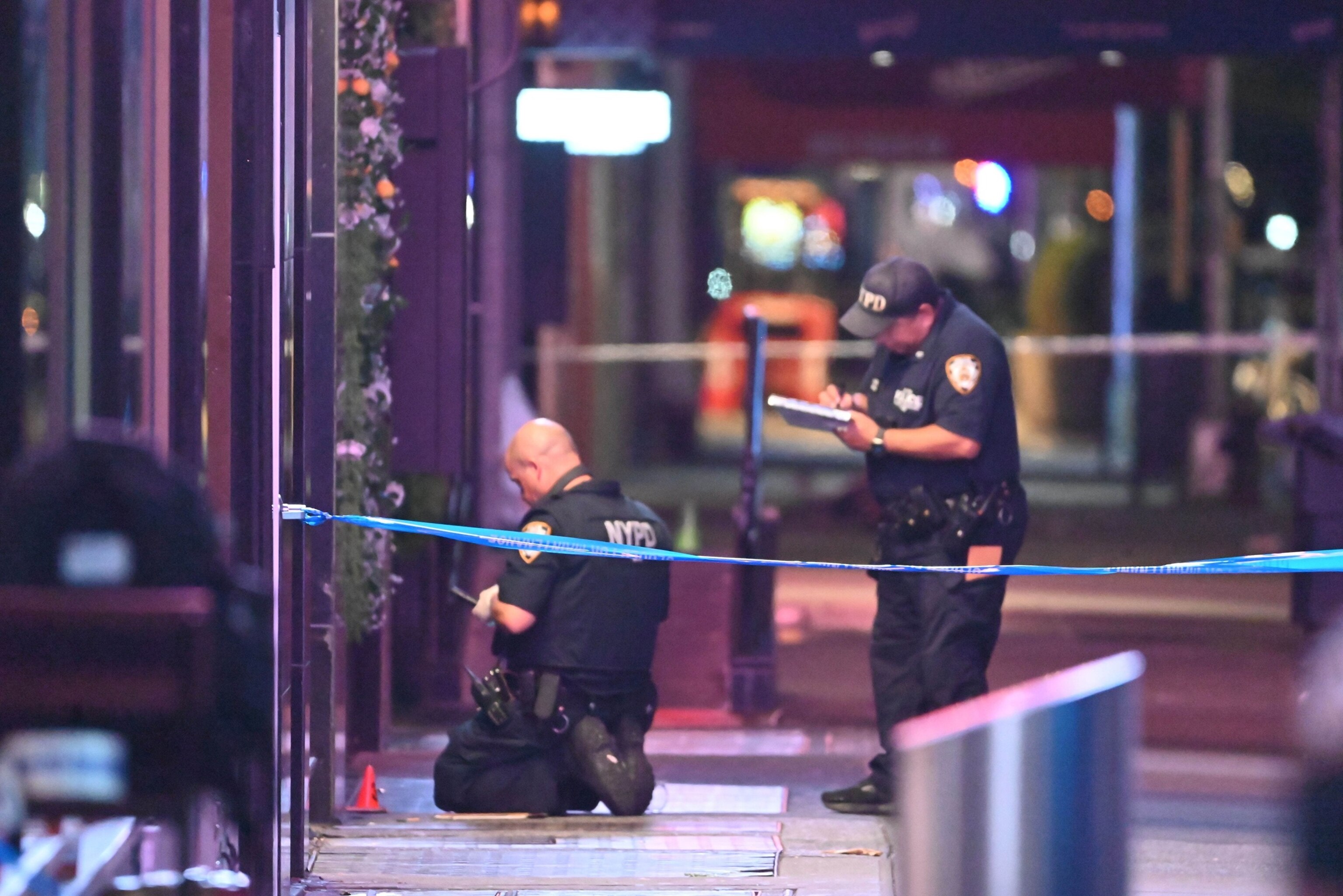 PHOTO: Officers of the New York City Police Department recover evidence at the shooting scene in Times Square. 