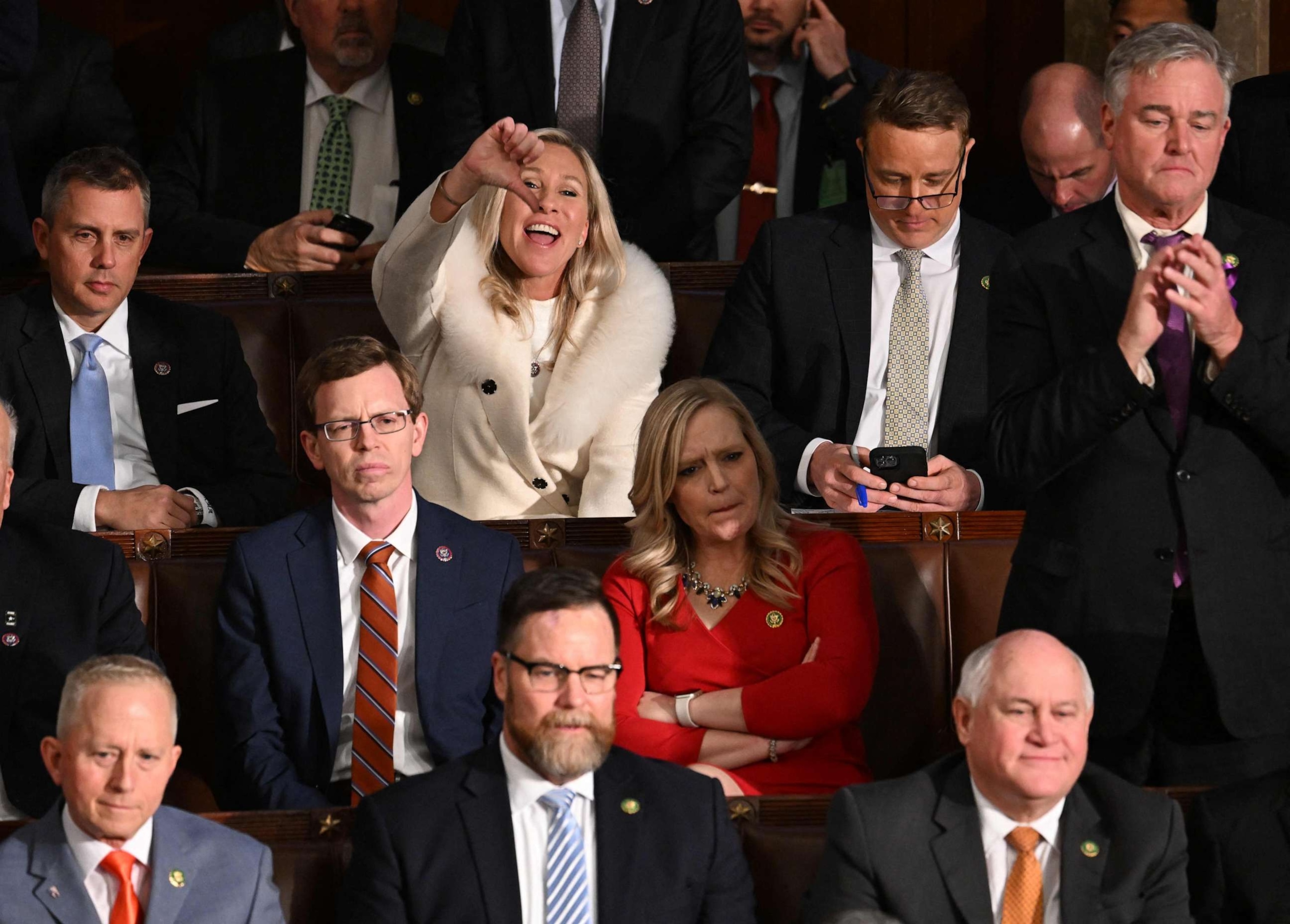 PHOTO: Republican Representative Marjorie Taylor Greene (R-GA) gives a thumb down as President Joe Biden delivers the State of the Union address at the Capitol in Washington, DC, Feb. 7, 2023.