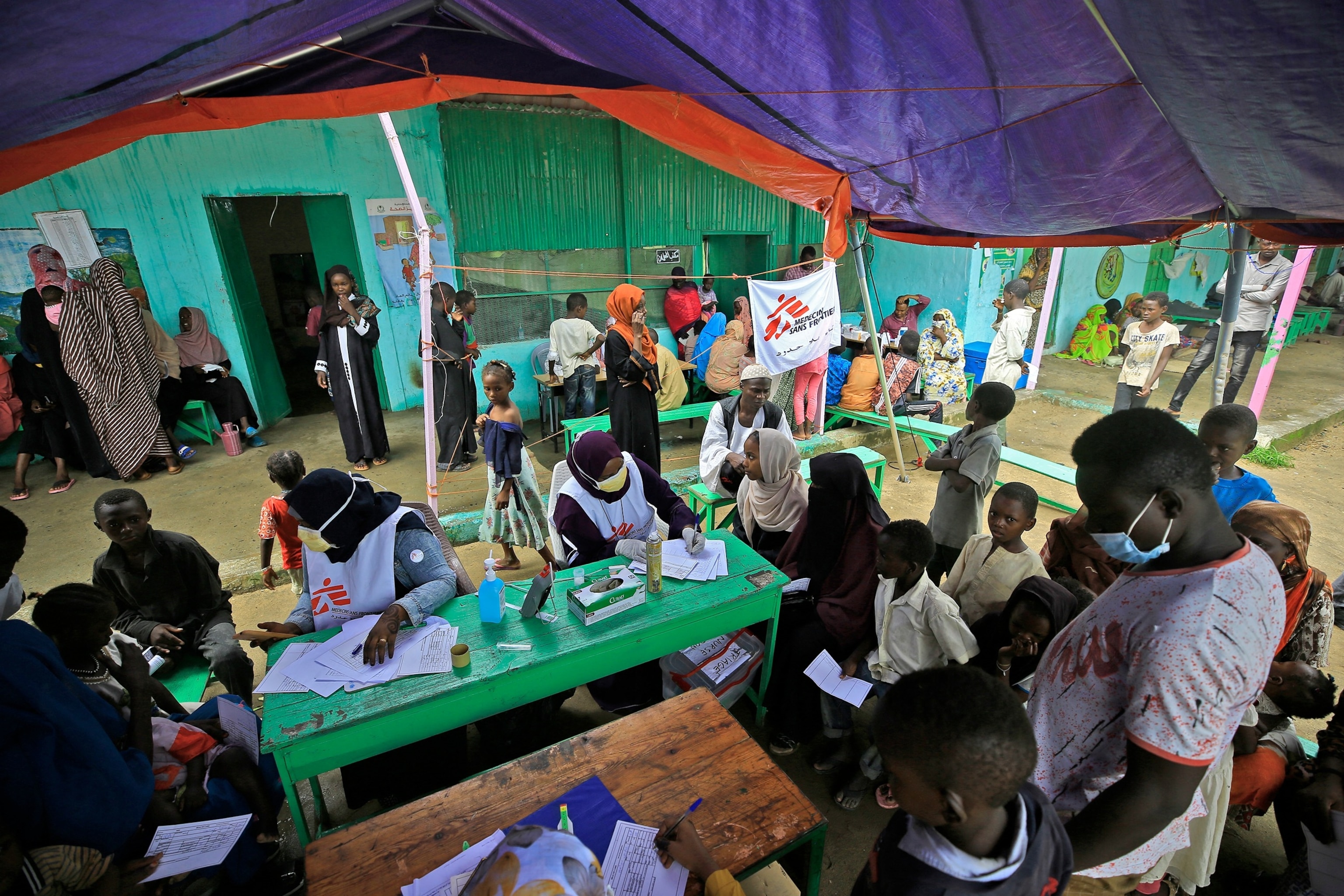 PHOTO: In this Aug. 7, 2022, file photo, people wait at a clinic set up by health authorities in collaboration with Medecins Sans Frontieres (Doctors Without Borders), at a camp for displaced people in Damazin, Sudan.