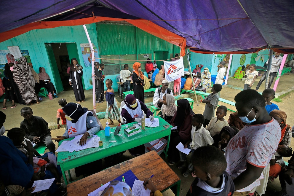 PHOTO: In this Aug. 7, 2022, file photo, people wait at a clinic set up by health authorities in collaboration with Medecins Sans Frontieres (Doctors Without Borders), at a camp for displaced people in Damazin, Sudan.