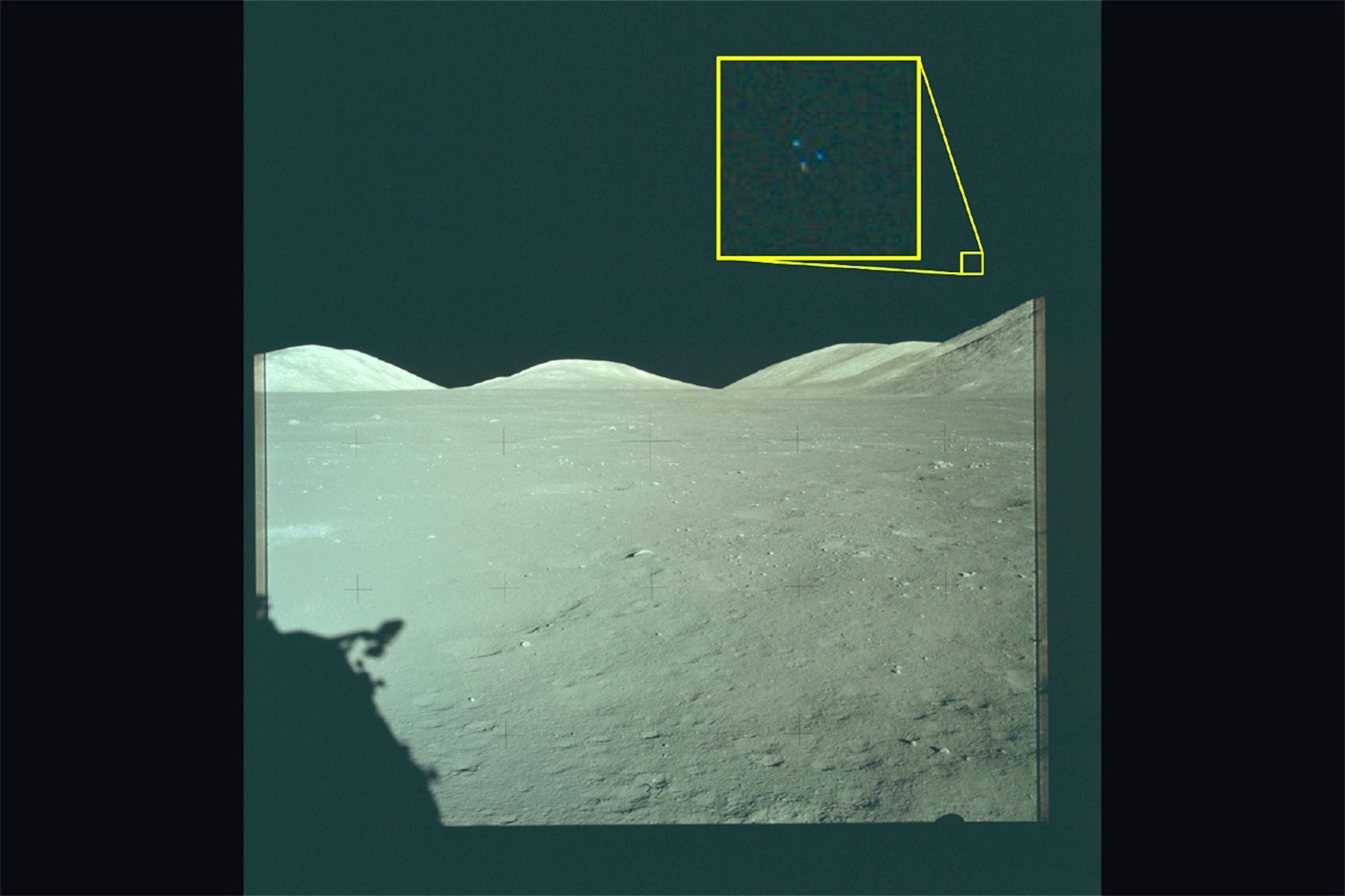 PHOTO: In this handout image provided by the Department of War an Archival image from the Apollo 17 mission to the Moon. The yellow box contains an enlarged area of the original photo in which three lights are visible above the lunar terrain. 