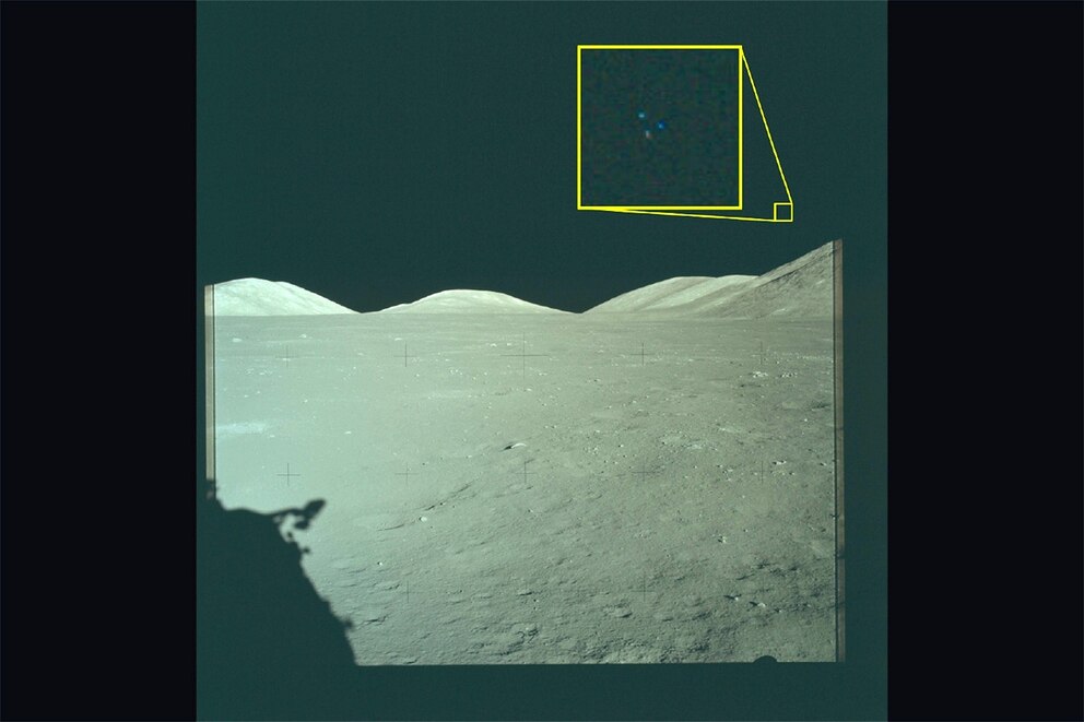 PHOTO: In this handout image provided by the Department of War an Archival image from the Apollo 17 mission to the Moon. The yellow box contains an enlarged area of the original photo in which three lights are visible above the lunar terrain. 