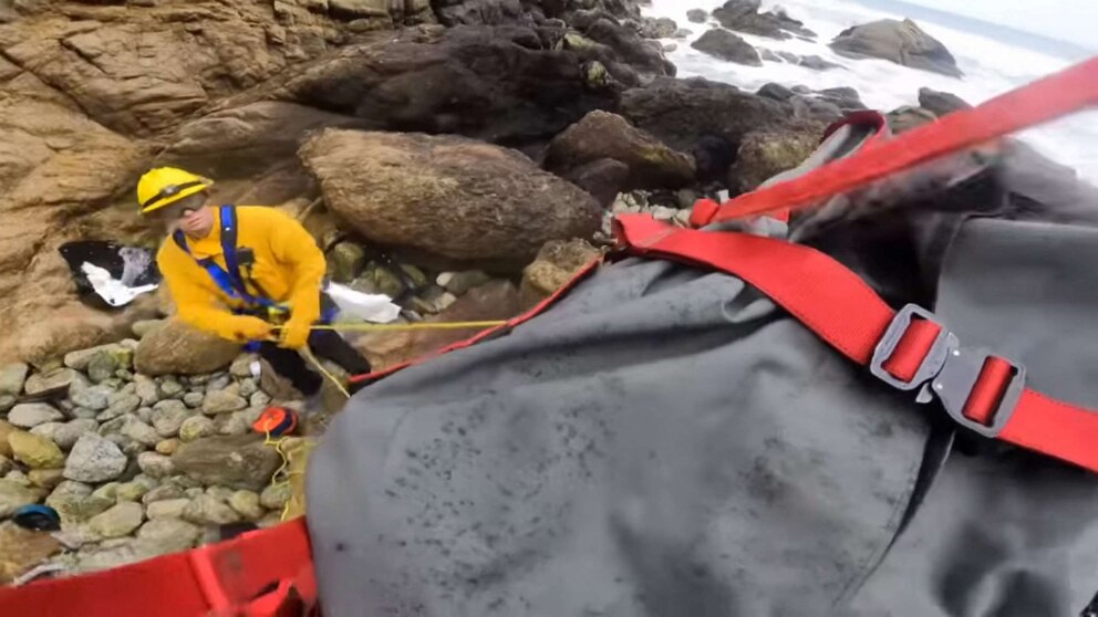 PHOTO: A crash victim is lifted to a helicopter during a rescue operation after a vehicle carrying two adults and two children went over a cliff in Devil's Slide, San Mateo county, Calif. Jan. 2, 2023.