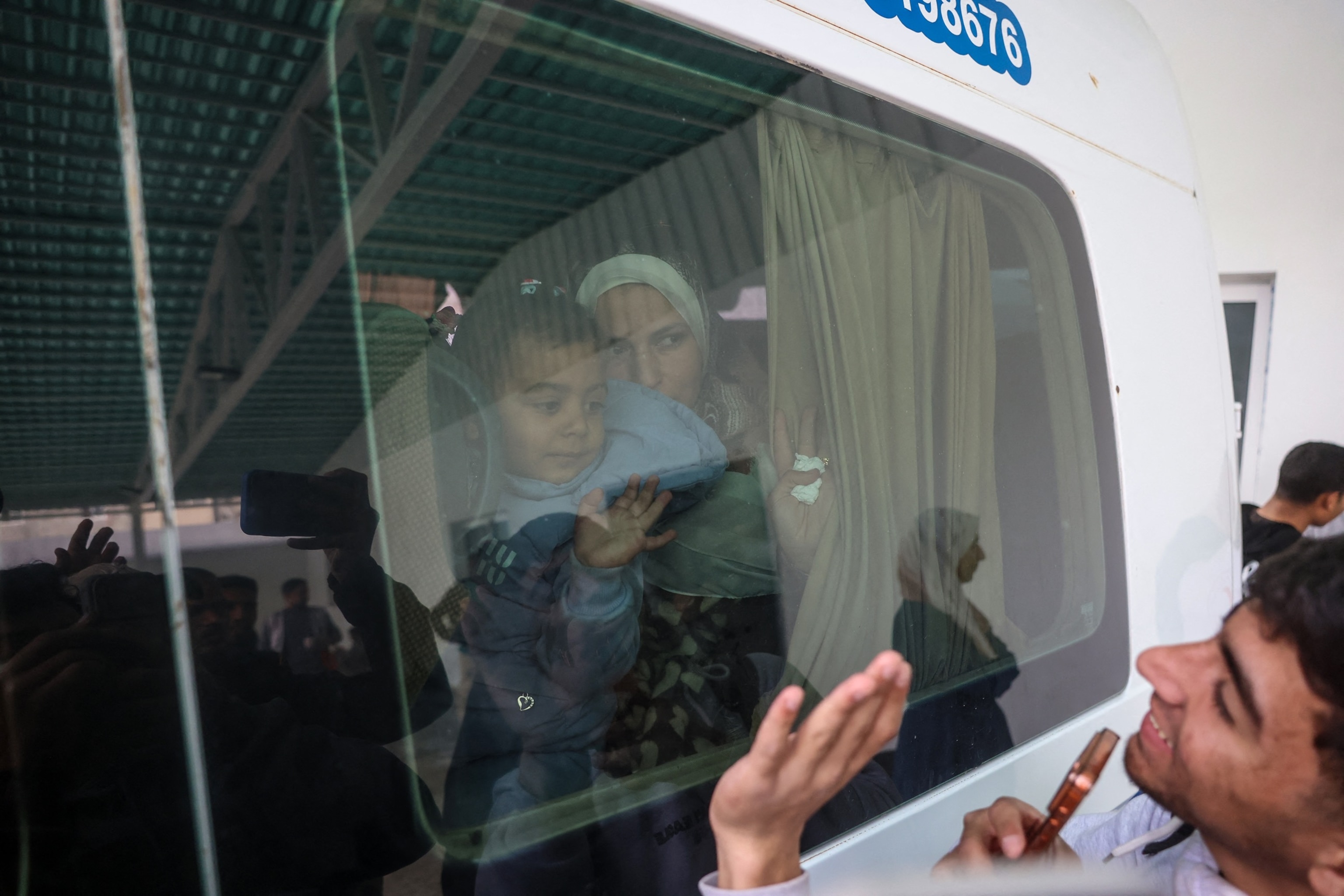PHOTO: A Palestinians child waves from the window of a bus evacuating war-wounded and patients, accompanied by relatives, as they ready to leave the Gaza Strip, in Khan Yunis, in the southern Gaza Strip on Feb. 2, 2026. 