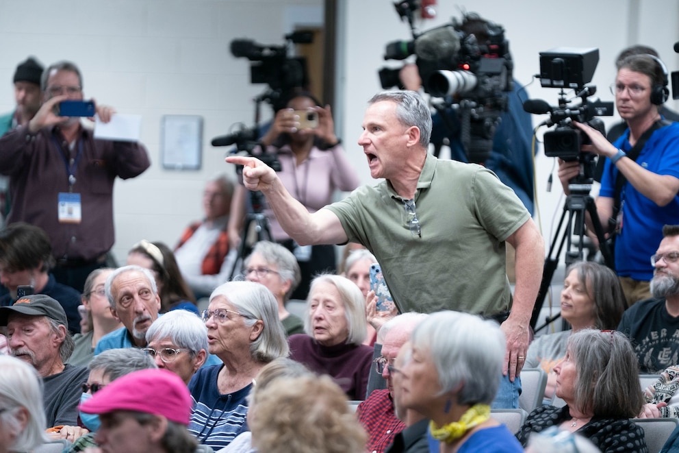 PHOTO: A man shouts at Rep. Chuck Edwards during a congressional town hall meeting on March 13, 2025 in Asheville, North Carolina.