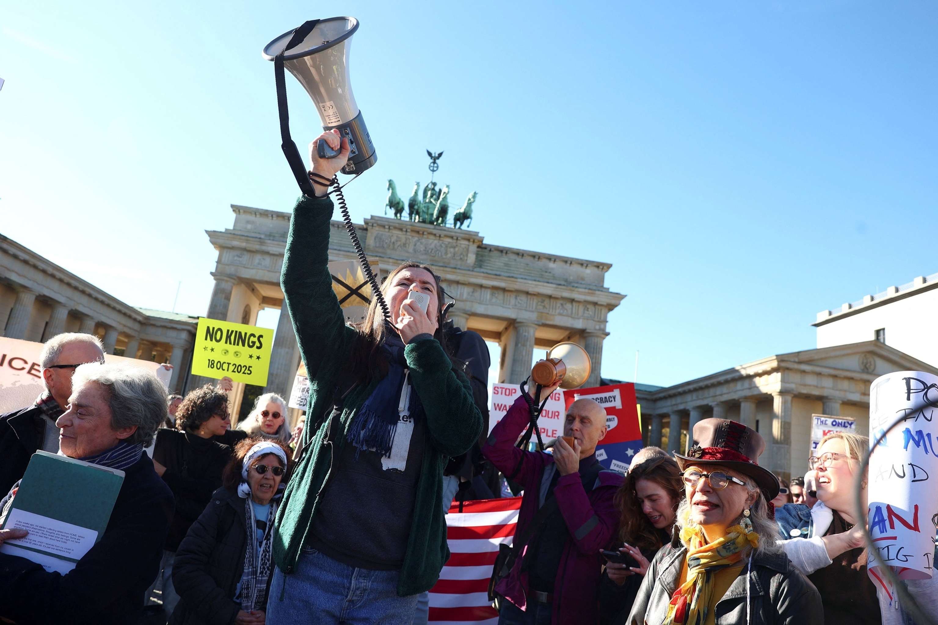 PHOTO: A demonstrator uses a megaphone during a "No Kings" rally against U.S. President Donald Trump and his administration, near the U.S. embassy in Berlin, Oct. 18, 2025.