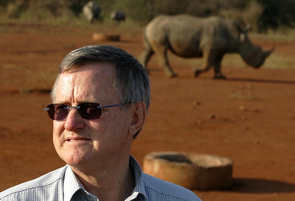 PHOTO: Zimbabwe-born, multi-millionaire game farmer John Hume poses September 30, 2004 in front of a black male rhinoceros outside the northeastern town of Malelane, next to Kruger National Park. 