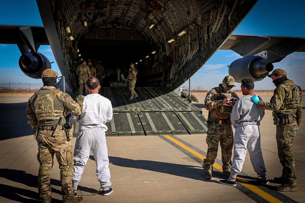 PHOTO: The first U.S. military aircraft to carry detained migrants to Guantanamo Bay is boarded from an unspecified location in the U.S.