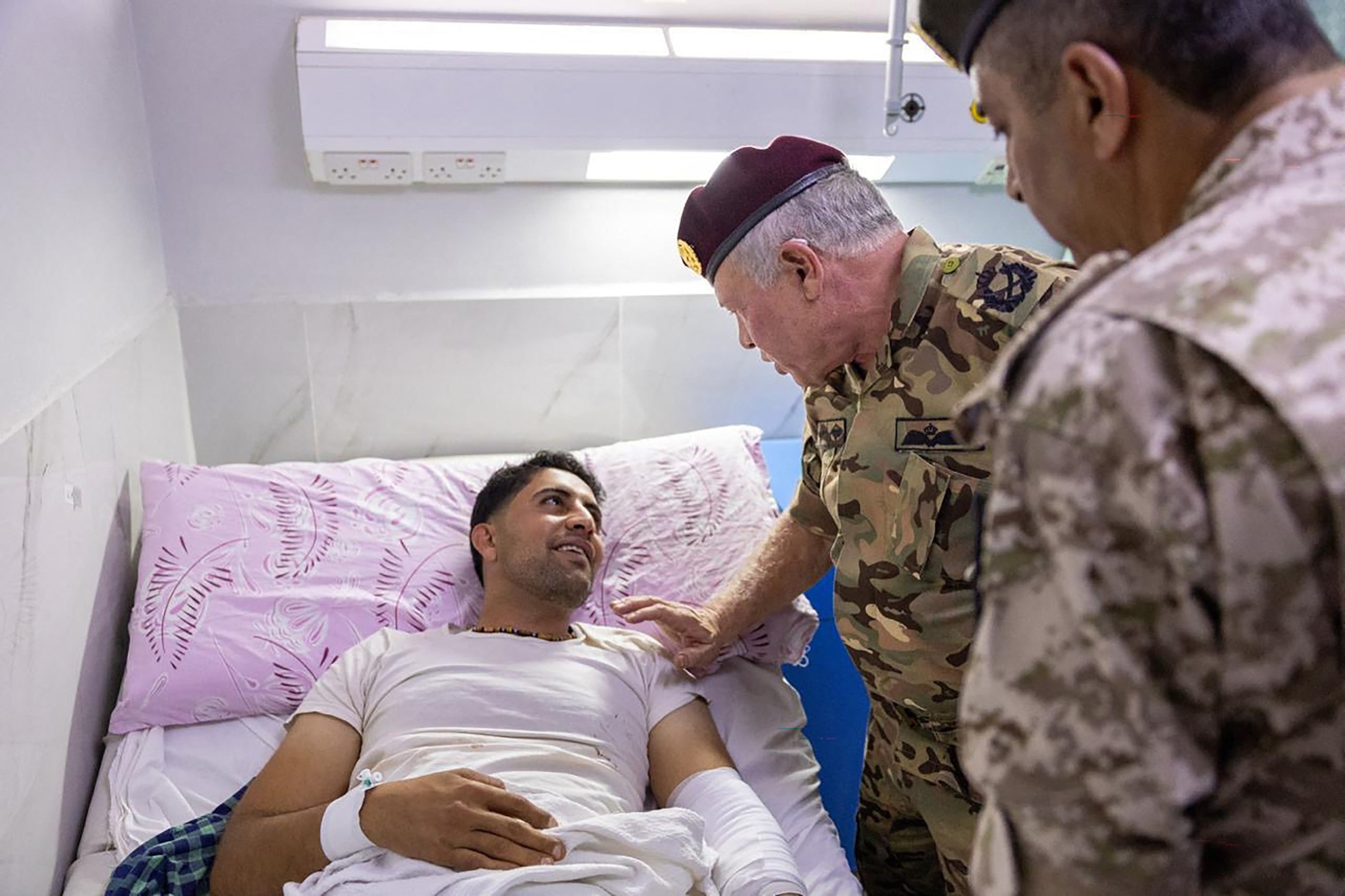 PHOTO: ThisOct. 23, 2026 handout image shows Jordan's King Abdullah II (C) visiting Prince Ali Military Hospital in Karak to check on those who were injured in the attack on a Greek Orthodox church in the village of Hammoud in Karak governorate. 