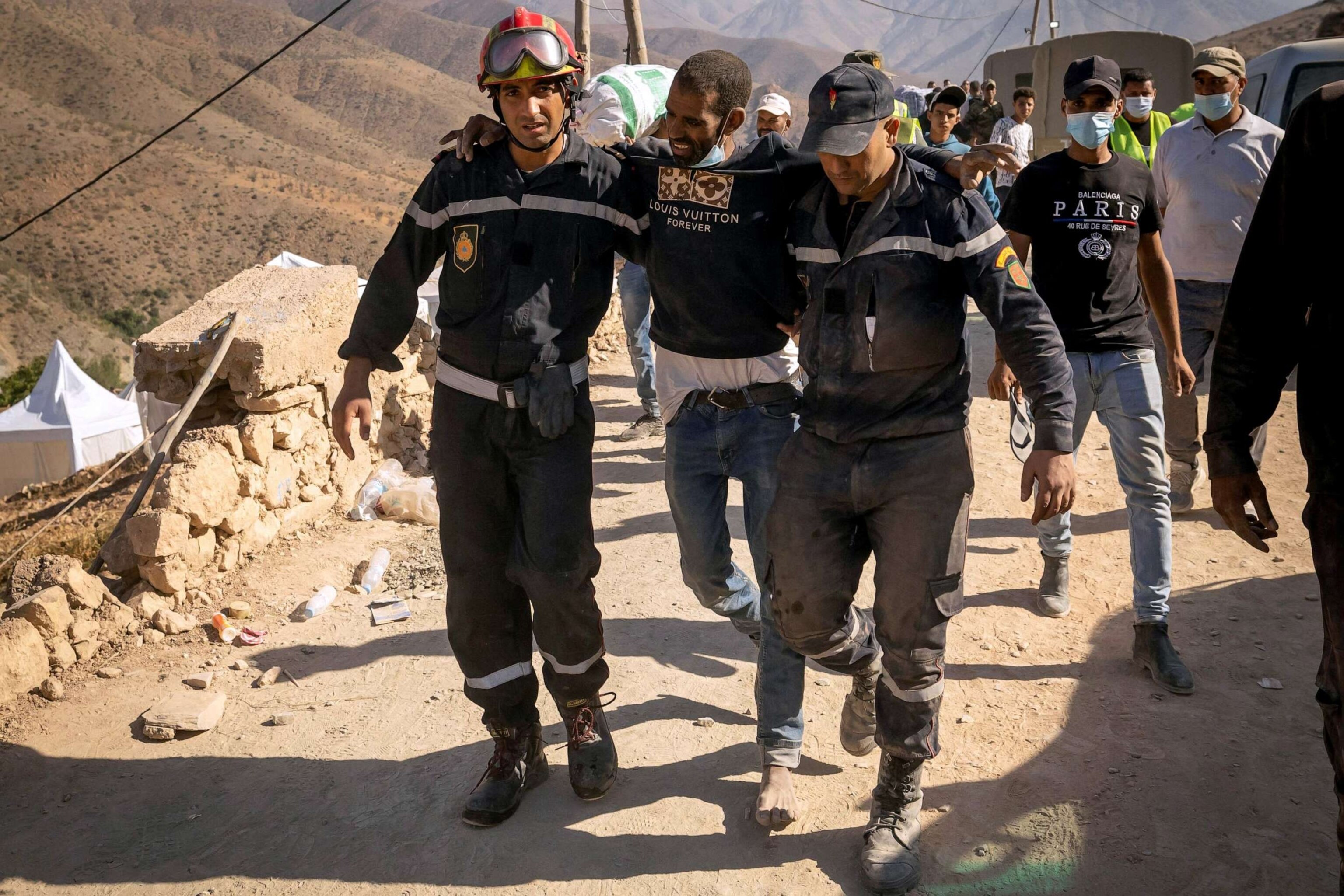 PHOTO: Rescuers help an injured man in the earthquake-hit village of in Imi N'Tala near Amizmiz on September 13, 2023.