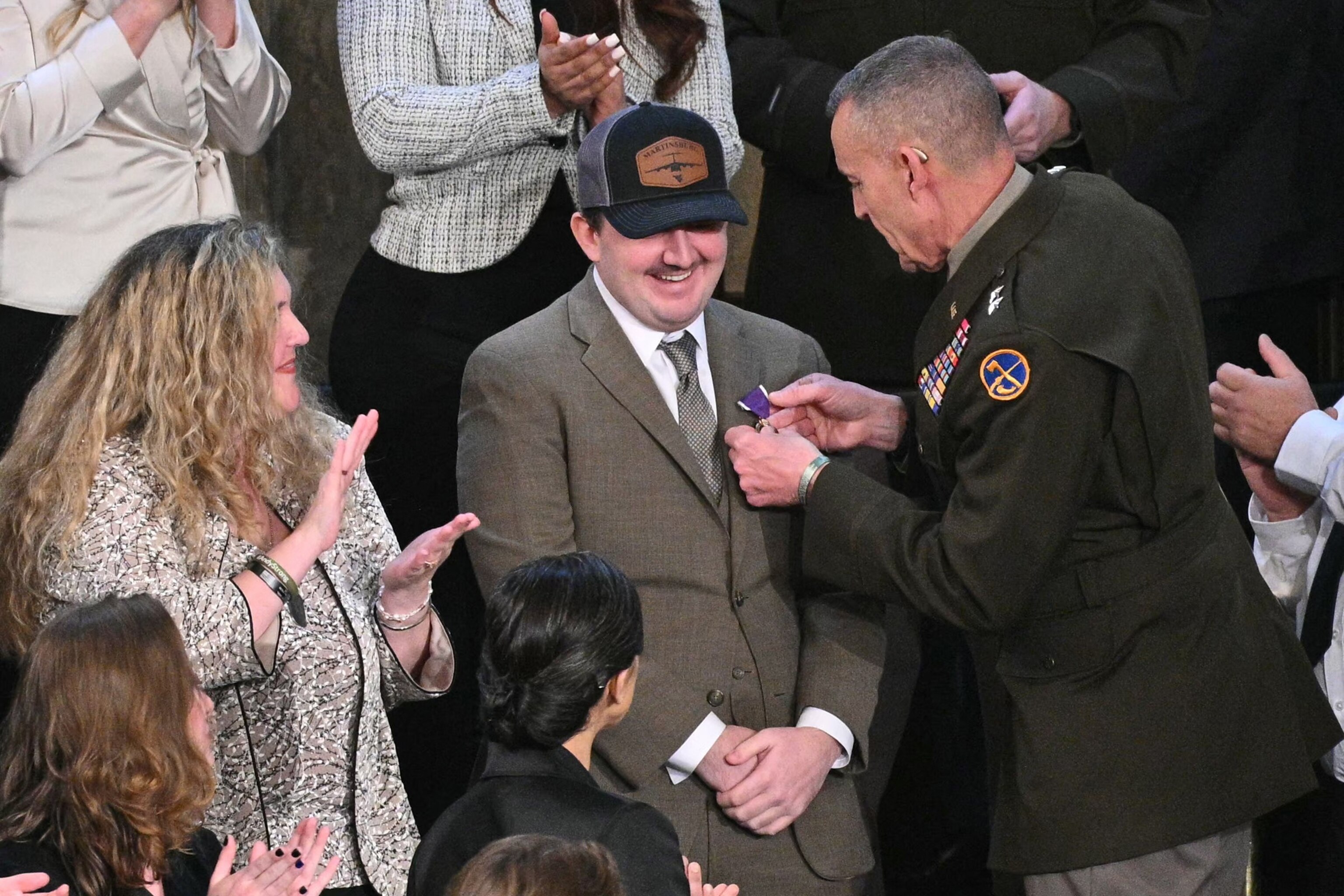 PHOTO: National Guard Staff Sgt. Andrew Wolfe receives a Purple Heart as he is recognized by President Donald Trump as he delivers the State of the Union address in the House Chamber of the US Capitol in Washington, D.C., on Feb. 24, 2026. 
