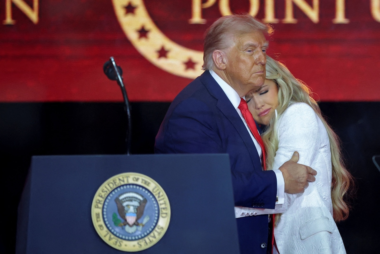 President Donald Trump comforts Erika Kirk, during a memorial service for her husband, slain conservative commentator Charlie Kirk, in Glendale, Arizona, Sept. 21, 2025. Carlos Barria/Reuters