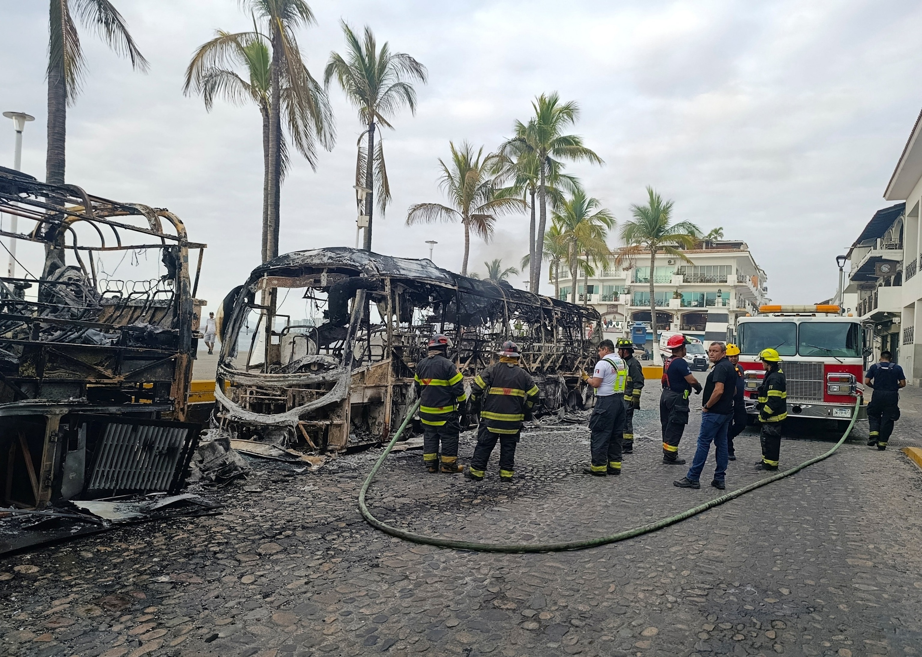 PHOTO: Firefighters work at the site where buses were set on fire at a tourist area, in Puerto Vallarta, Mexico, February 22, 2026.