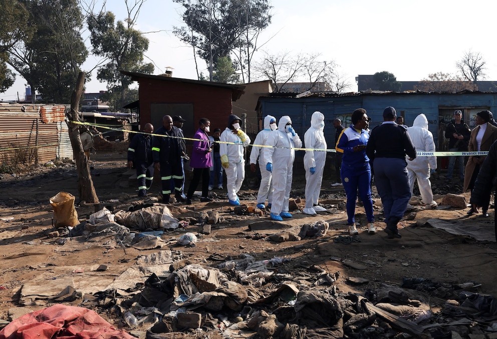 PHOTO: Members of the forensics team arrive at the scene after, according to the police, gunmen opened fire at an informal settlement in Cleveland, Johannesburg, South Africa, June 10, 2026.