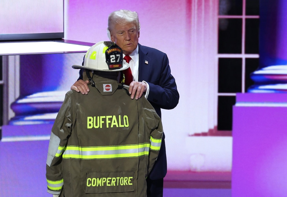 PHOTO: Former President Donald Trump embraces the turnout coat and helmet of former Buffalo Township Volunteer Fire Department chief Corey Comperatore, who was killed at his rally, on Day 4 of the Republican National Convention, Wis., July 18, 2024.